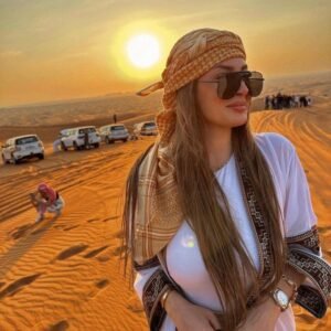 “Tourists enjoying an Arabian Desert Safari in Dubai with dune bashing, camel rides, sunset views, and traditional Arabian dance shows.