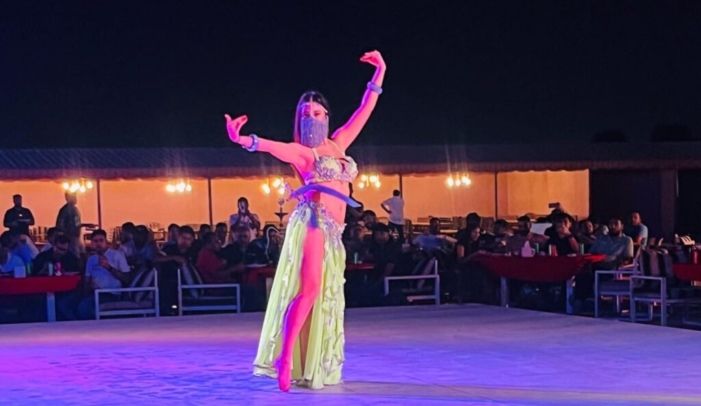 Tourist enjoying an evening desert safari with a warm sunset and thrilling dune ride.