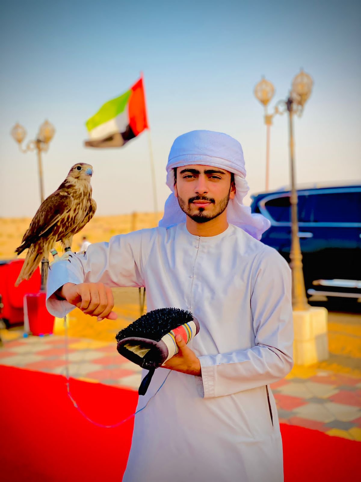Best Dubai desert safari falcon experience in UAE with traditional Emirati man