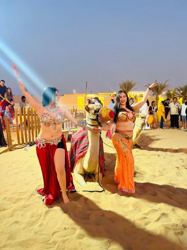 Dubai desert camp featuring live belly dance, Tanoura show, fire show, bonfire, and BBQ dinner under the stars.