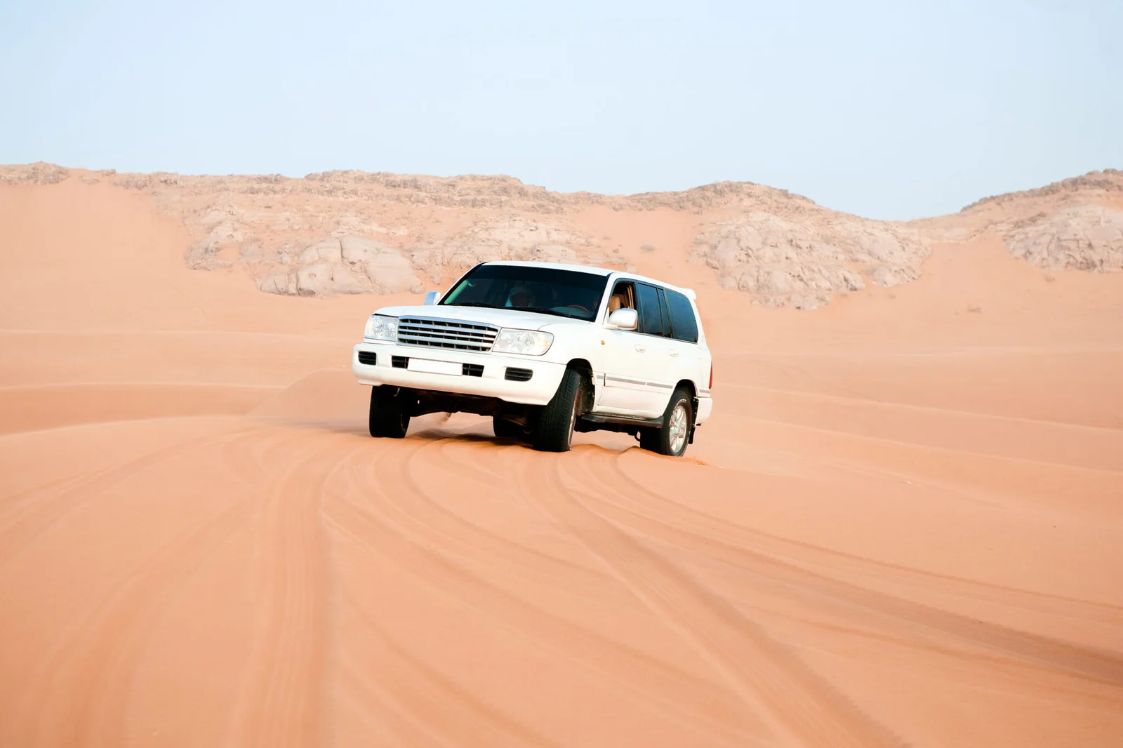 Premium 4x4 Land Cruiser parked alone on a sand dune during a private VIP desert safari in Dubai