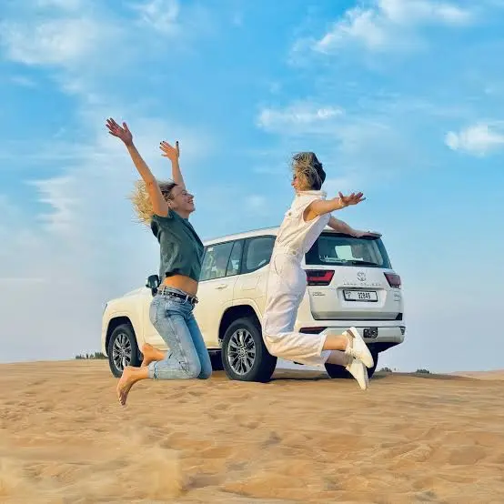 Private 4x4 Dubai desert safari tour crossing red sand dunes with experienced driver