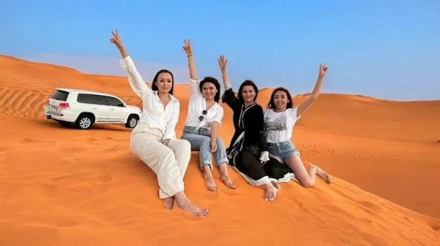 Family enjoying a private 4x4 desert safari in Dubai with dune bashing and sunset views