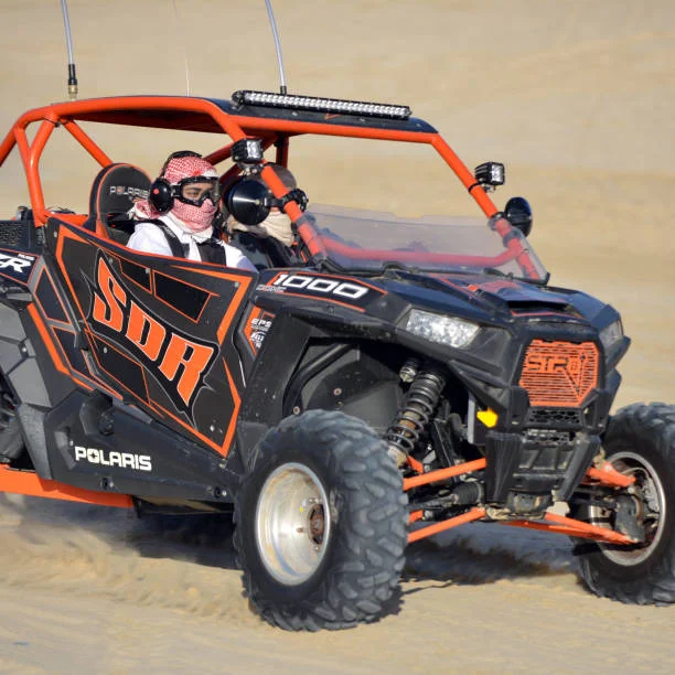 Rider on a quad bike crossing sand dunes during a Dubai desert safari adventure