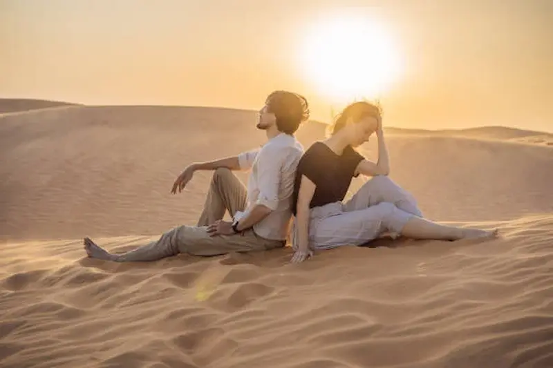 Golden sunrise light over sand dunes at a popular desert safari photography spot in Dubai
