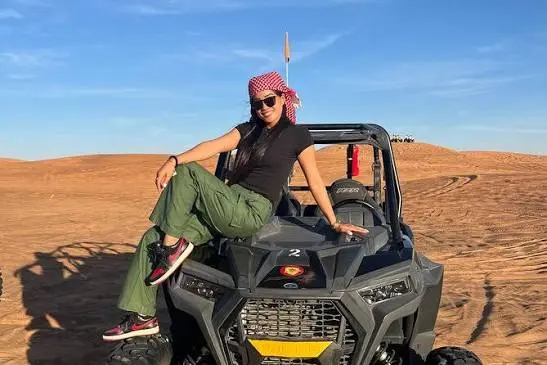 Quad biking across Dubai desert during morning safari