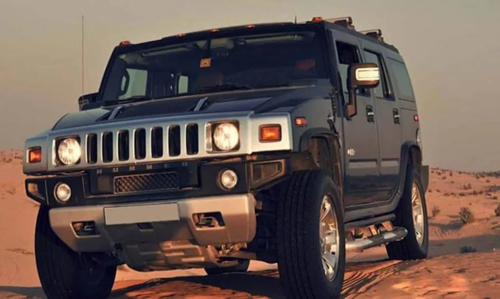 Hummer safari driving through Dubai red dunes